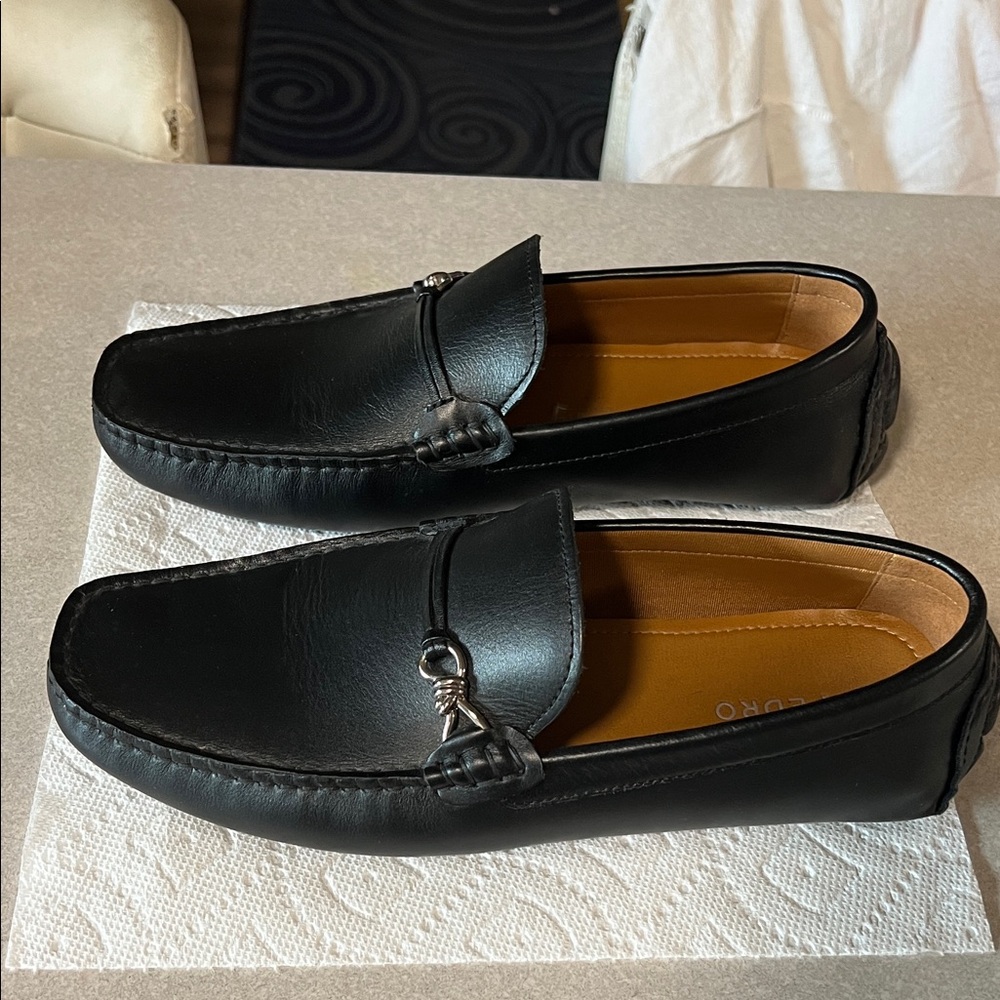 Pedro’s black leather loafers